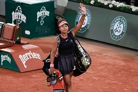 Naomi Osaka leaves center court after losing match